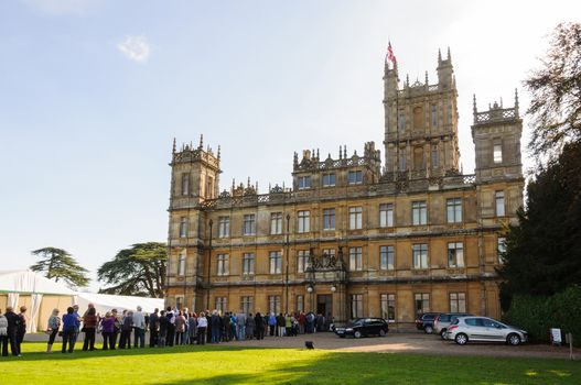 NEWBURY, UK - CIRCA OCTOBER 2011: People  queuing to visit Highclere Castle which  is the main setting for the ITV period drama Downton Abbey.