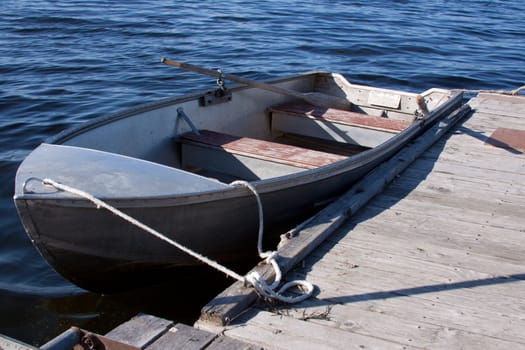 A row boat tied to a dock.