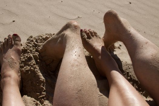 Sandy feet showing a couple is enjoying their vacation on the beach.