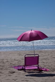Time to relax on the beach in this beach chair and umbrella.