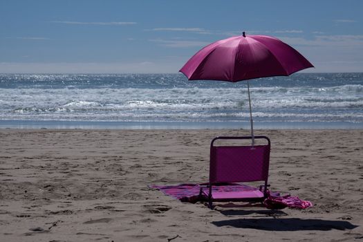 Time to relax in this beach chair with umbrella on the beach.