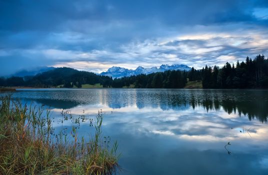 rainy sunrise over Geroldsee lake with view on Karwendel mountain range, Bavaria