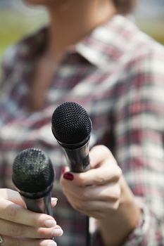 A journalist is making a interview with a microphone