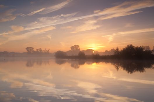 calm misty sunrise over wild lake, Drenthe, Netherlands