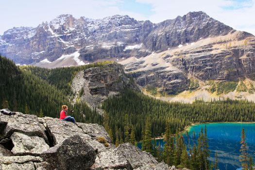 Young woman admiting Lake O'Hara, Yoho National Park, British Columbia, Canada