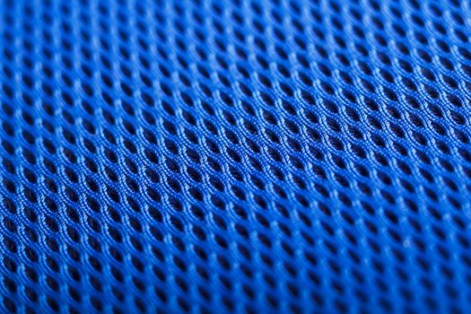 Blue background. Mesh fabric texture. Macro perspective