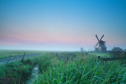 sunrise over Dutch farmland with windmill, Holland