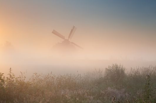 windmill silhouette in sunrise fog, Netherlands
