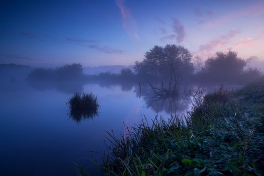 tranquil misty sunrise over lake, Drenthe, Netherlands