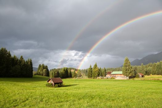 colorful rainbow during rain in Alps, Bavaria, Germany