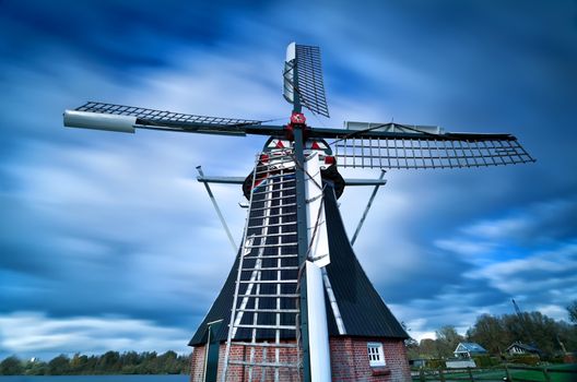 Dutch windmill and clouded sky with long exposure, Groningen, Netherlands