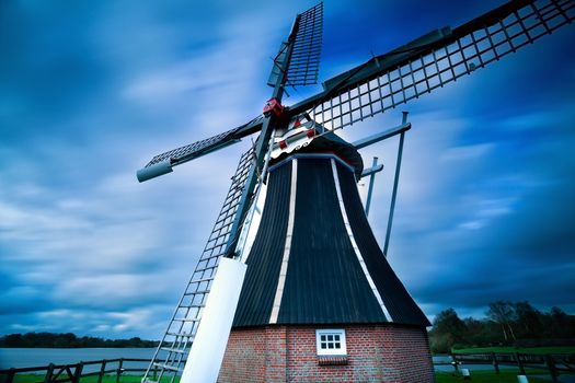 Dutch windmill over blurred sky with long exposure, Holland