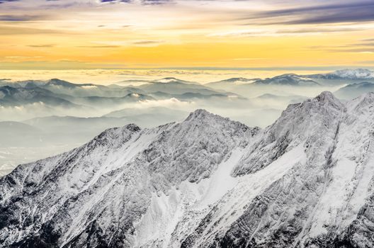 Scenic view of misty winter mountains with colorful sunset, High Tatras, Slovakia