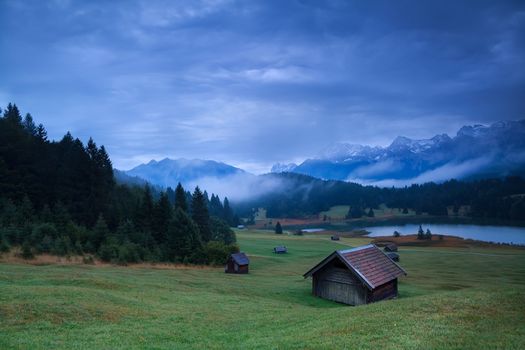 wooden hut on meadow by Geroldsee lake in dusk, Germany