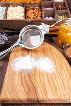 Traces in the form of heart on the background of powdered sugar