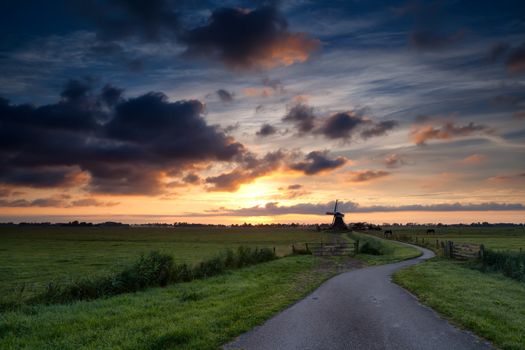 bike road to windmill at sunrise, Holland