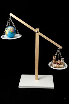 Globe Planet Earth and Money on a Two Pan Balance