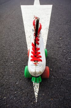 Old Vintage White Skate Boot on the Asphalt Sterret