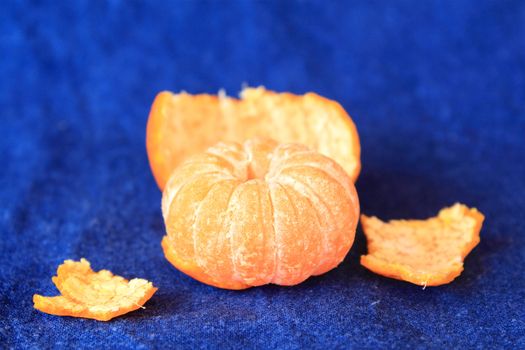 Orange mandarin on blue background