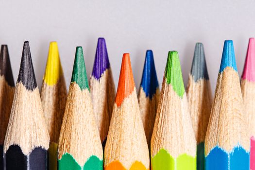 Brightly colored wooden pencils closeup shot background