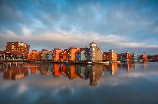 colorful buildings on water during sunrise, Reitdiephaven, Groningen, Netherlands