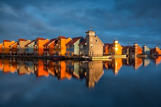 beautiful colorful buildings on water in gold sunshine, Reitdiephaven, Groningen, Netherlands