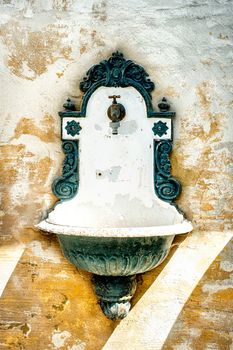 Antique green Washing Basin on a house facade