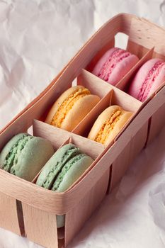 Multicolored macaroon in a box with three compartments