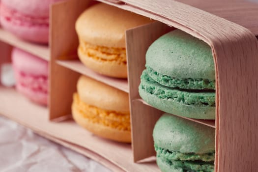 Multicolored macaroon in a box with three compartments