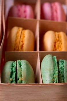Multicolored macaroon in a box with three compartments