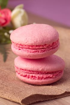 Pink macaroon with raspberry flavor on sacking