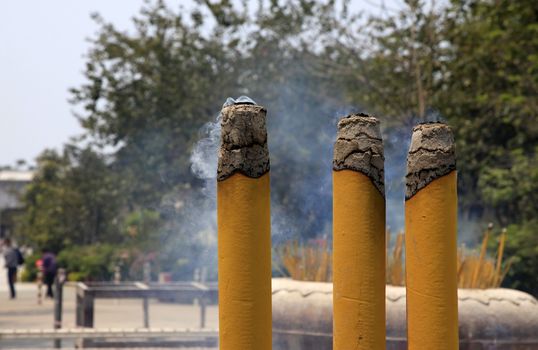 Burning incense sticks in stone bowl in Hong Kong