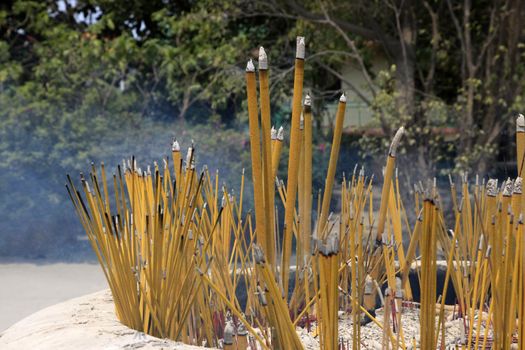 Burning incense sticks in stone bowl in Hong Kong