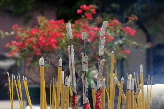 Burning incense sticks in stone bowl in Hong Kong