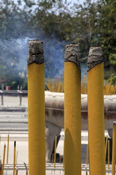 Burning incense sticks in stone bowl in Hong Kong