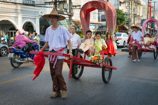 PHUKET, THAILAND - 07 FEB 2014: Rickshas with passenger  take part in procession parade of annual old Phuket town festival. 