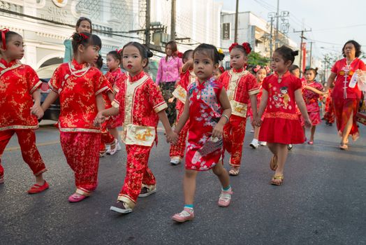 PHUKET, THAILAND - 07 FEB 2014: Small children take part in procession parade of annual old Phuket town festival. 