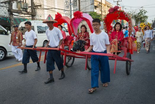 PHUKET, THAILAND - 07 FEB 2014: Rickshas with passenger  take part in procession parade of annual old Phuket town festival. 