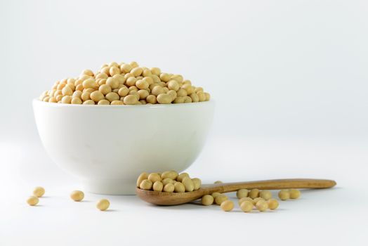 Heap of soya beans on bowl on white background