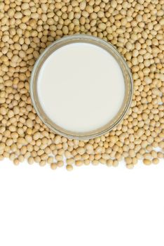 Soymilk and soy beans over white background