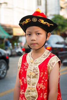 PHUKET, THAILAND - 07 FEB 2014: Young boy take part in procession parade of annual old Phuket town festival. 