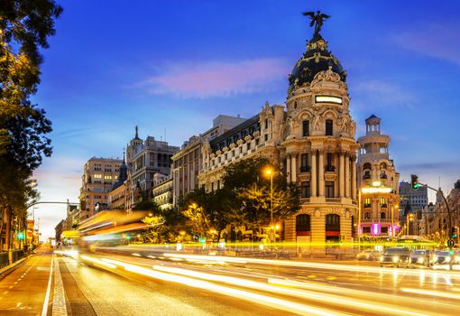 Rays of traffic lights on Gran via street, main shopping street in Madrid at night. Spain, Europe. 