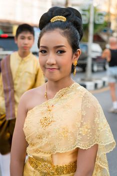 PHUKET, THAILAND - 07 FEB 2014: Young woman in wedding dress take part in procession parade of annual old Phuket town festival. 