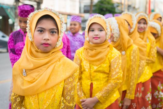 PHUKET, THAILAND - 07 FEB 2014: Children in muslim headscarf take part in procession parade of annual old Phuket town festival. 