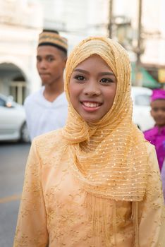 PHUKET, THAILAND - 07 FEB 2014: Young muslim woman take part in procession parade of annual old Phuket town festival. 