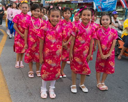 PHUKET, THAILAND - 07 FEB 2014: Children in red traditional dress take part in procession parade of annual old Phuket town festival. 