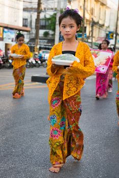 PHUKET, THAILAND - 07 FEB 2014: Young girl in traditional dress takes part in procession parade of annual old Phuket town festival. 