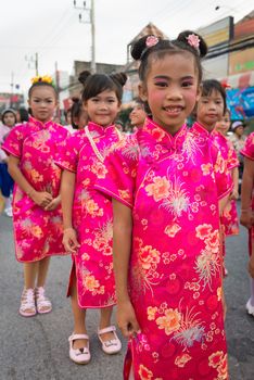 PHUKET, THAILAND - 07 FEB 2014: Children in red traditional dress take part in procession parade of annual old Phuket town festival. 