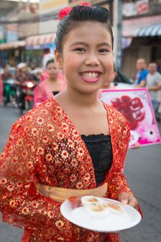 PHUKET, THAILAND - 07 FEB 2014: Happy girl take part in procession parade of annual old Phuket town festival. 