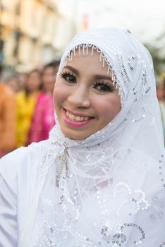 PHUKET, THAILAND - 07 FEB 2014: Beautiful woman in white muslim headscarf take part in procession parade of annual old Phuket town festival. 
